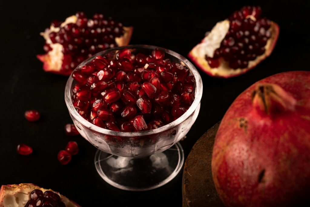 pexels photo 10654218 10654218 Close-up of fresh pomegranate seeds in a clear glass bowl, highlighting their vibrant red color.